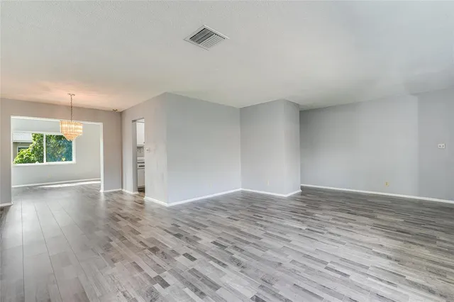 a kitchen with granite countertop a sink stove refrigerator and cabinets