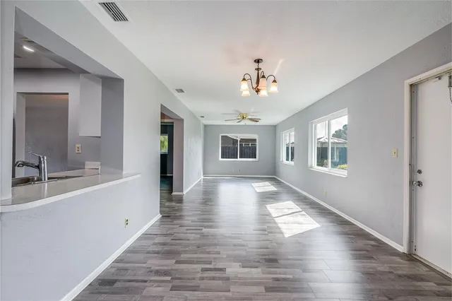 a view of a kitchen with wooden floor and a kitchen