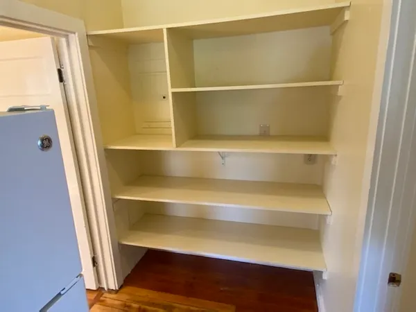 a view of walk in closet with empty racks
