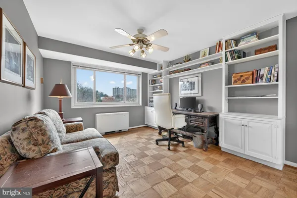 a work room with furniture and a bookshelf