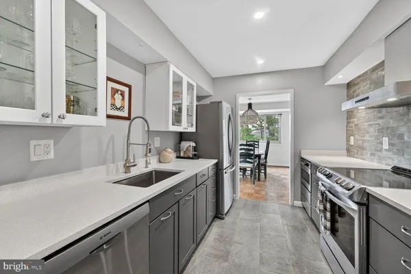 a kitchen with sink stove and cabinets