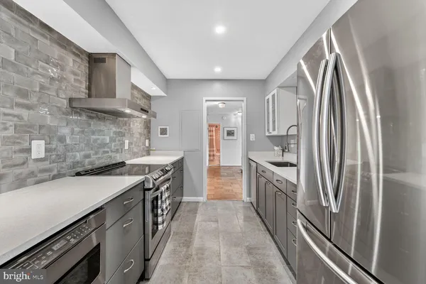 a kitchen with stainless steel appliances granite countertop a sink and a stove