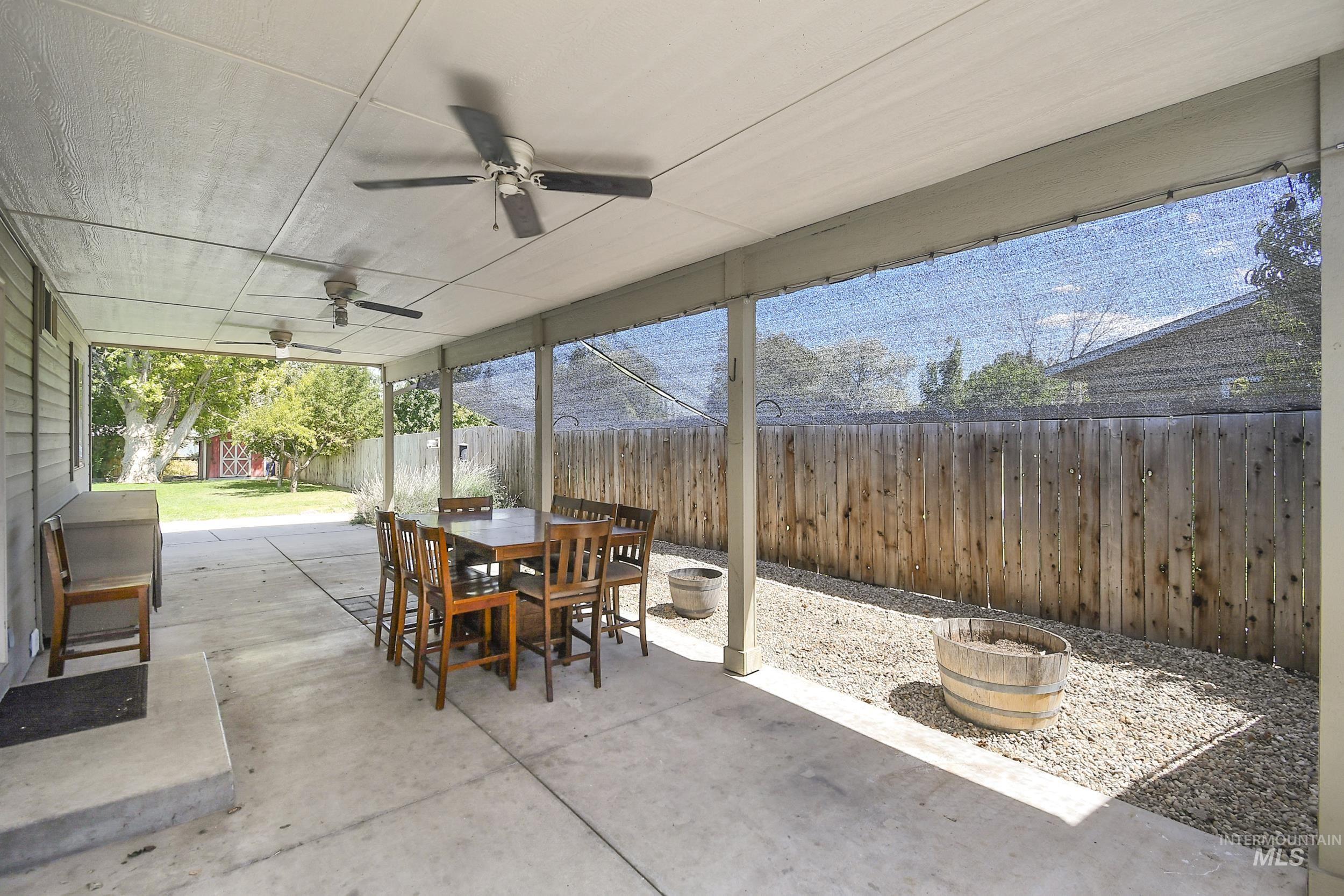 1108 East Ustick Road Caldwell, ID 83607 - Photo 26 of 30 Covered patio featuring concrete flooring, multiple ceiling fans, and a privacy screen