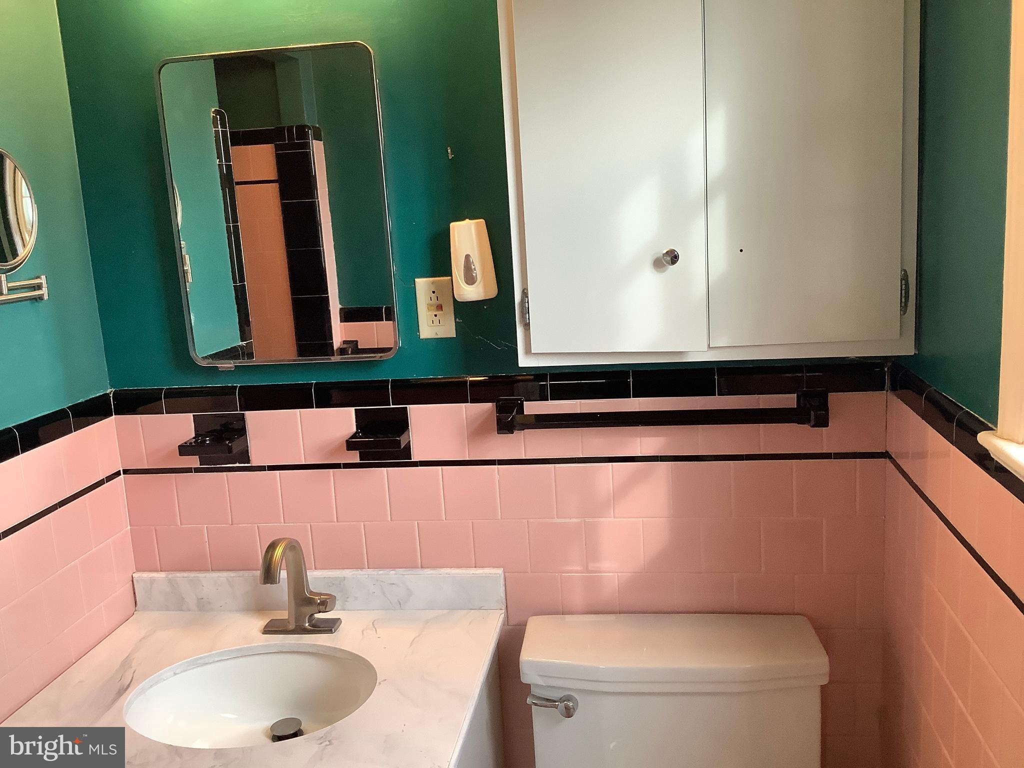 5702 Ogden Road Bethesda, MD 20816 - Photo 11 of 23 a bathroom with a sink and a mirror