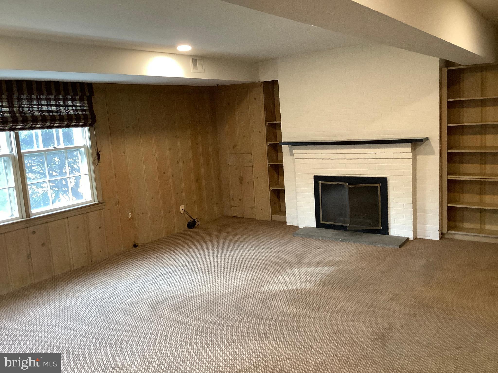 5702 Ogden Road Bethesda, MD 20816 - Photo 18 of 23 an empty room with windows and fireplace