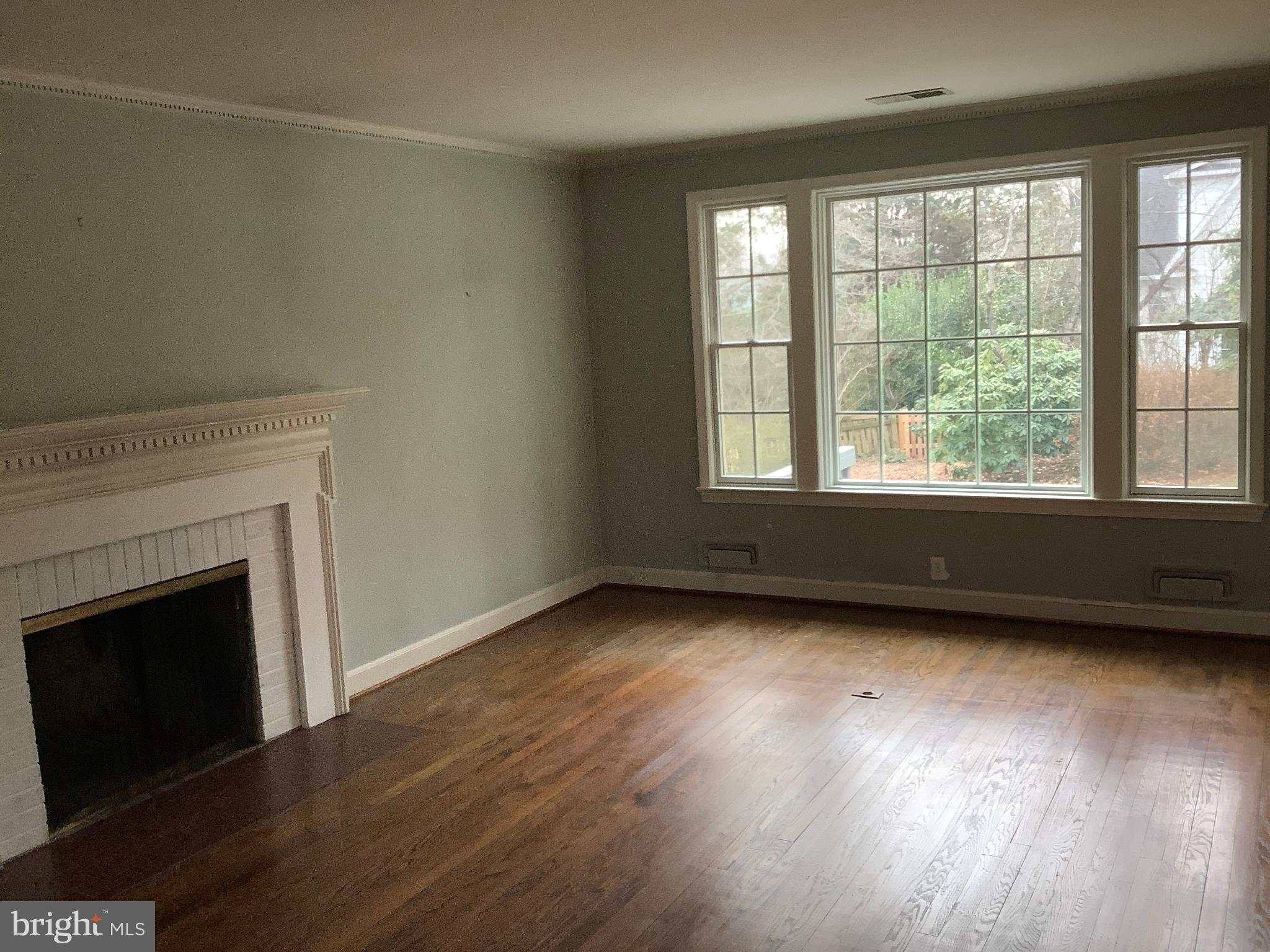 5702 Ogden Road Bethesda, MD 20816 - Photo 8 of 23 a view of an empty room with wooden floor and a window