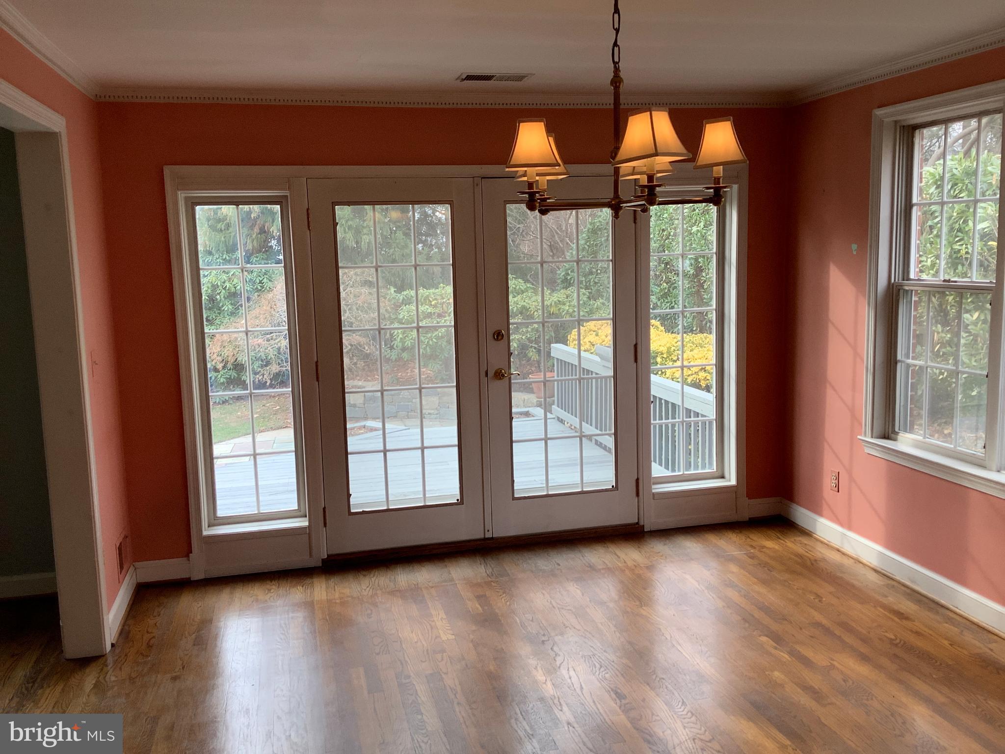 5702 Ogden Road Bethesda, MD 20816 - Photo 9 of 23 a view of an empty room with wooden floor and a window