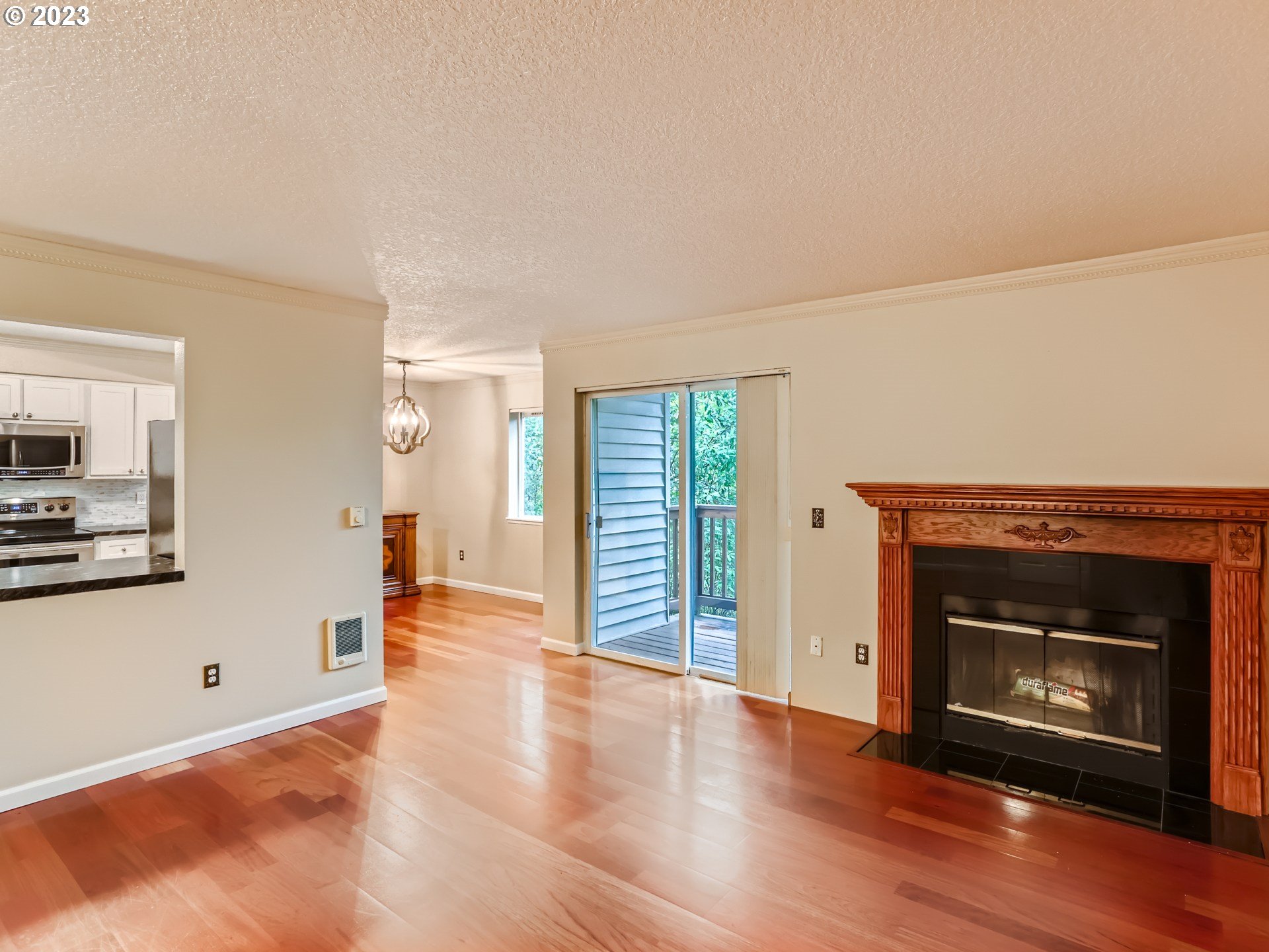 10660 Southwest Davies Road, Unit 30 Beaverton, OR 97008 - Photo 4 of 24 a view of a livingroom with wooden floor and a fireplace
