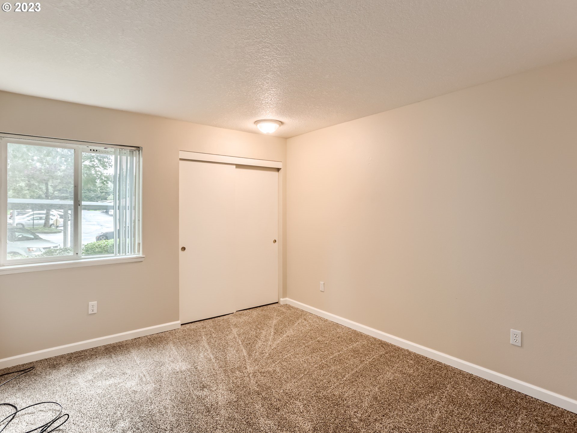 10660 Southwest Davies Road, Unit 30 Beaverton, OR 97008 - Photo 7 of 24 an empty room with windows and closet