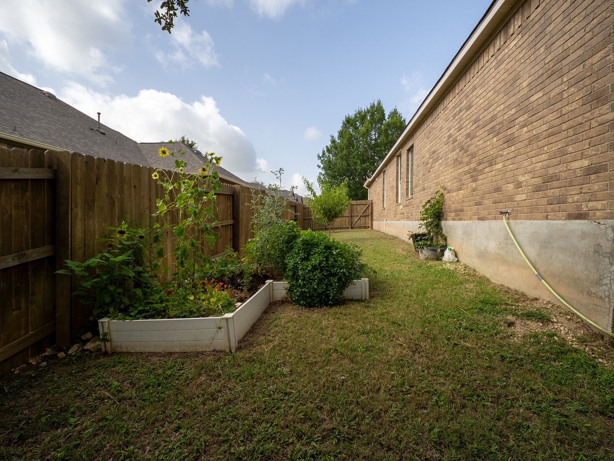 572 Big Meadow Road Austin, TX 78737 - Photo 29 of 32 A fenced backyard offers a dedicated garden space for green-thumbed residents.