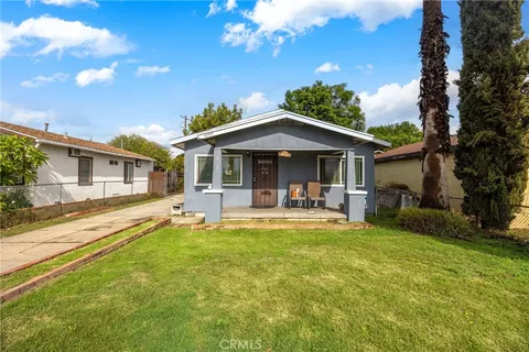 a front view of a house with swimming pool having outdoor seating