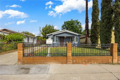 a view of house with a yard and entertaining space