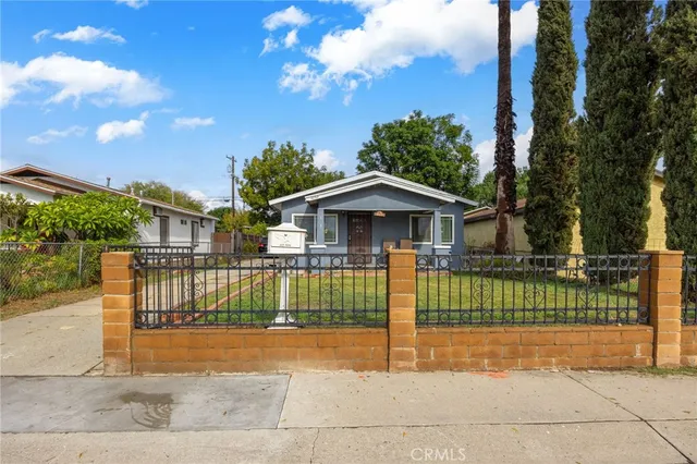 a view of house with a yard and entertaining space