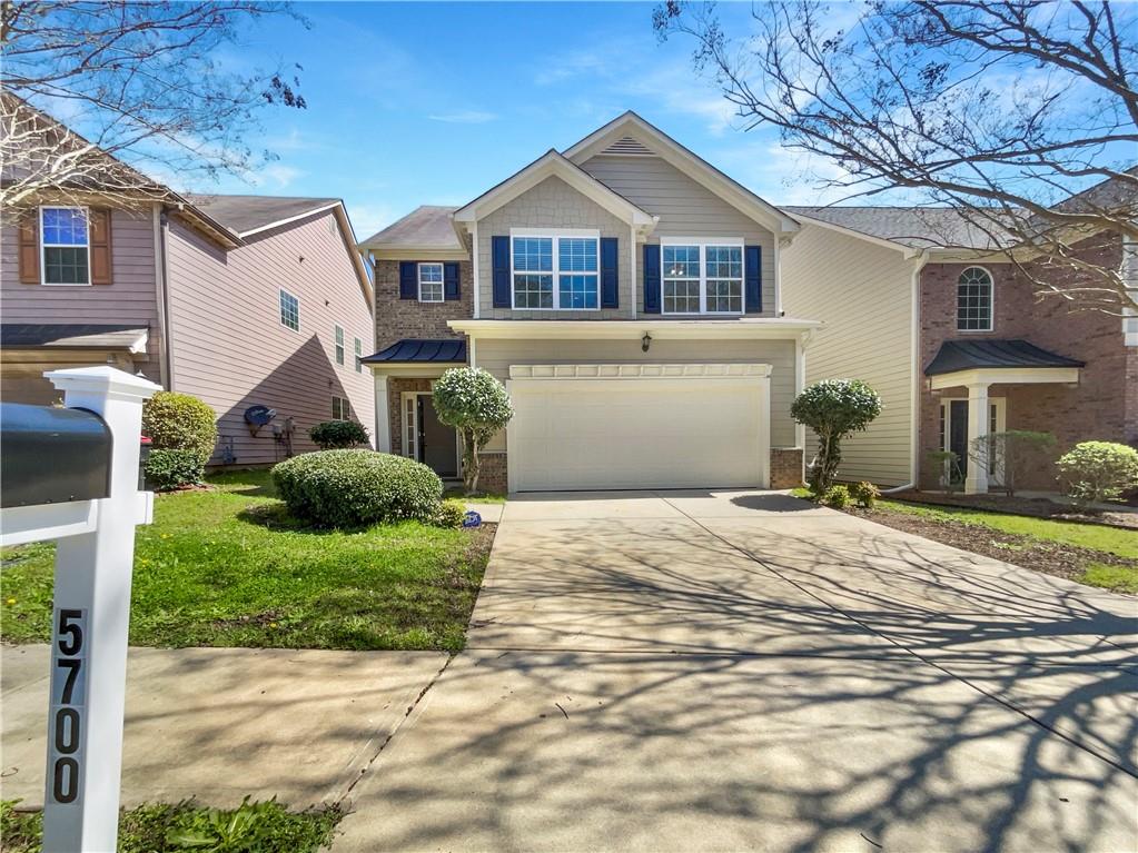 5700 Grande River Road Atlanta, GA 30349 - Photo 1 of 1 a front view of a house with a yard and garage