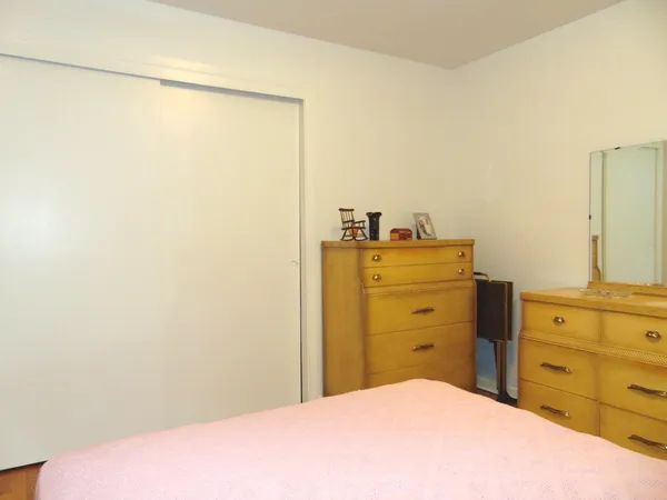 a bedroom with a bed and cabinets