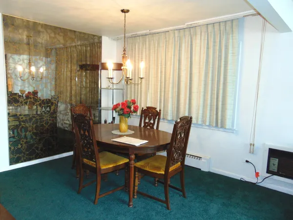a view of a dining room with furniture and a chandelier