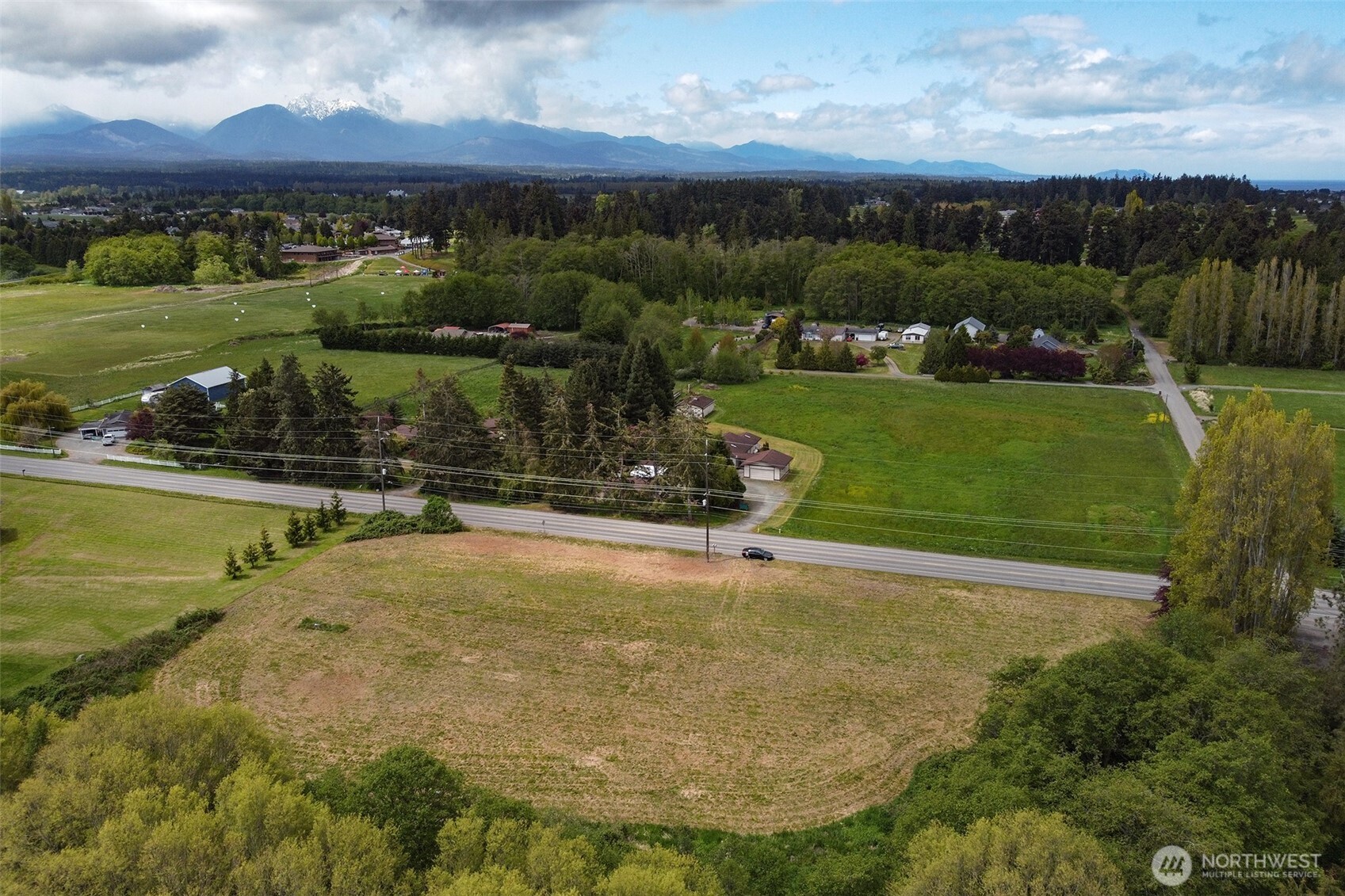 820 Cays Road Sequim, WA 98382 - Photo 4 of 35 an aerial view of a house with a garden and lake view