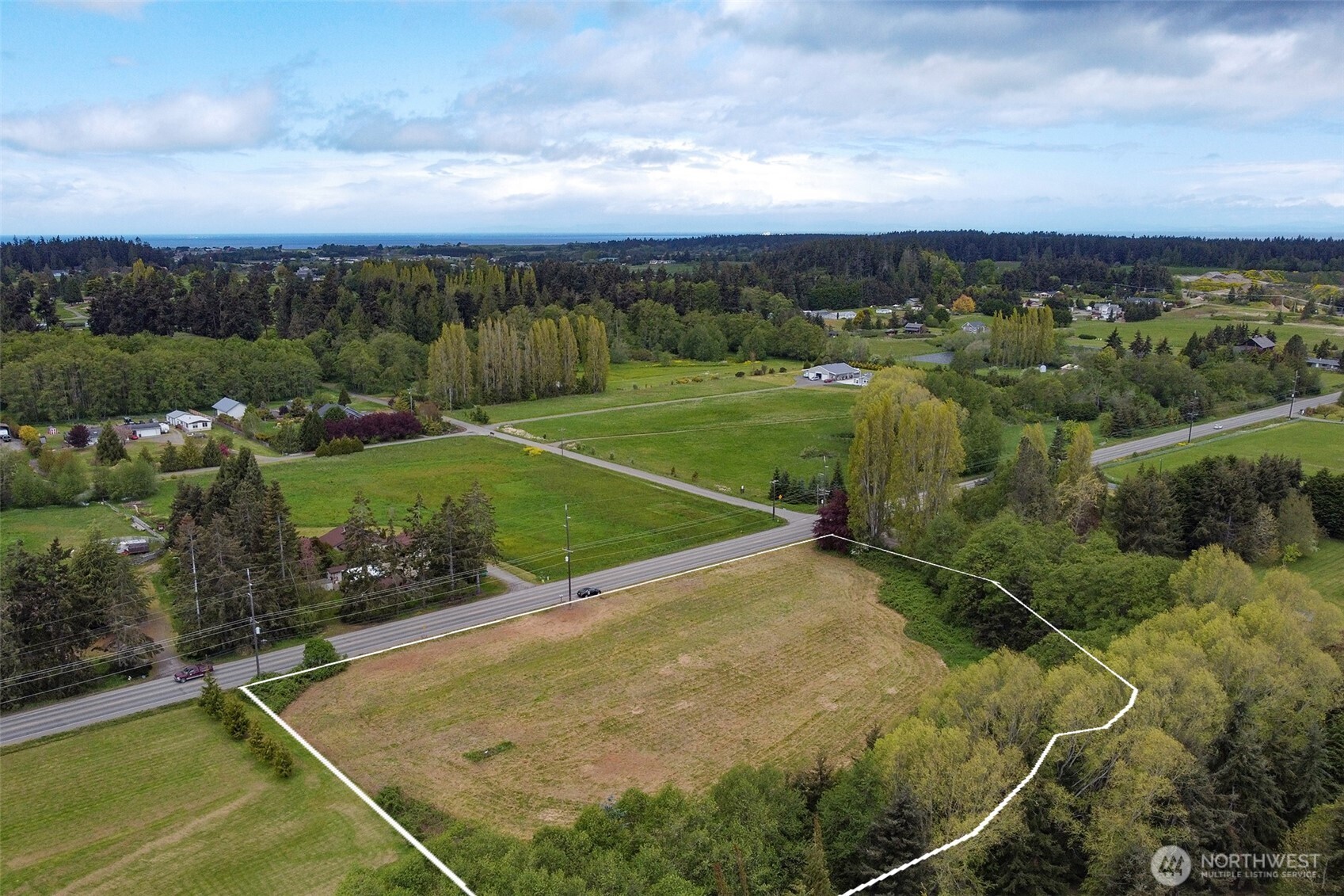 820 Cays Road Sequim, WA 98382 - Photo 5 of 35 an aerial view of a golf course with a lake view