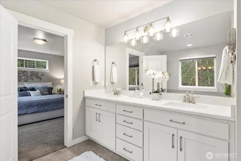 a bathroom with a double vanity sink mirror and double