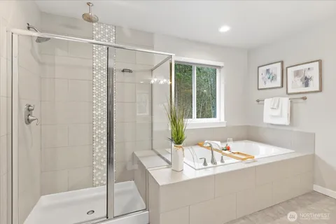 a bathroom with a tub sink and shower
