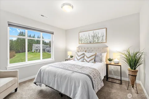 a bedroom with a large bed and a large window