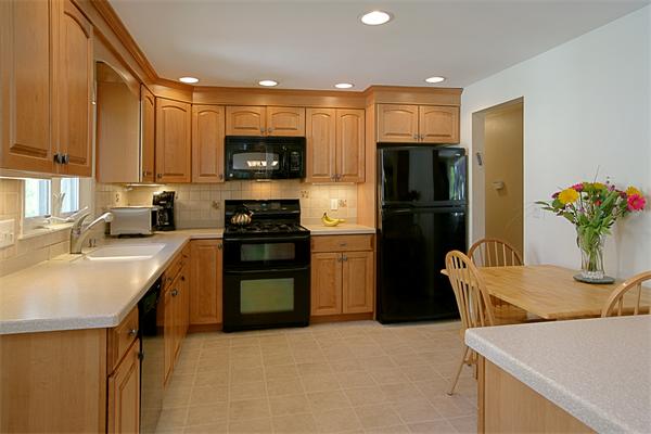 11 Marked Tree Road Needham, MA 02492 - Photo 5 of 9 a kitchen with a refrigerator a stove and a sink