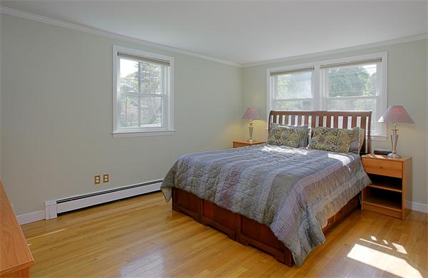 11 Marked Tree Road Needham, MA 02492 - Photo 6 of 9 a large bed sitting in a bedroom next to a window