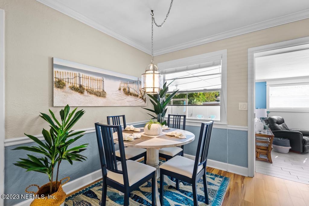 6712 E Road Jacksonville, FL 32216 - Photo 14 of 40 a dining room with furniture potted plants and wooden floor