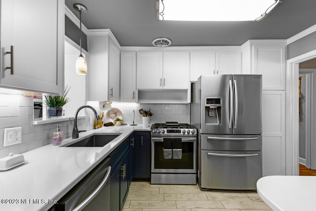 6712 E Road Jacksonville, FL 32216 - Photo 15 of 40 a kitchen with a sink stainless steel appliances and cabinets