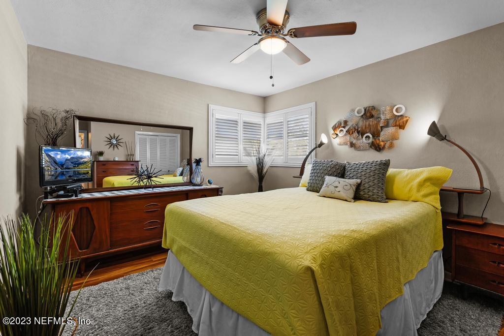 6712 E Road Jacksonville, FL 32216 - Photo 23 of 40 a bedroom with a bed and a chandelier