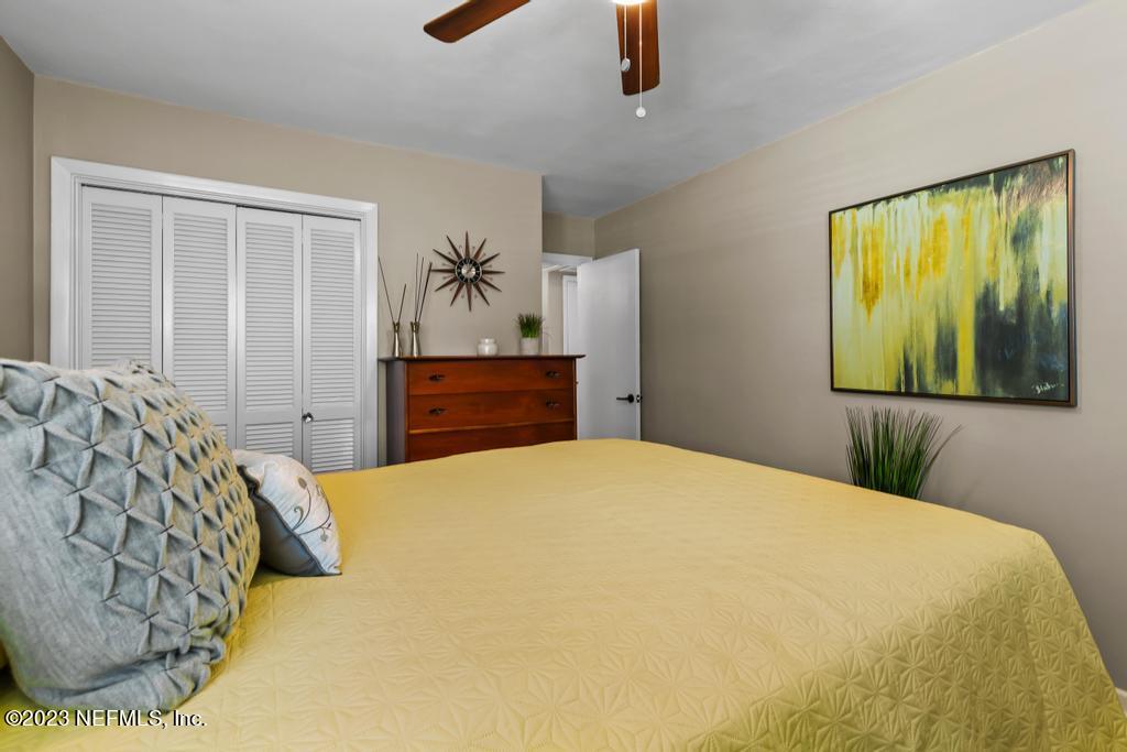 6712 E Road Jacksonville, FL 32216 - Photo 24 of 40 a bedroom with a bed and a painting on the wall