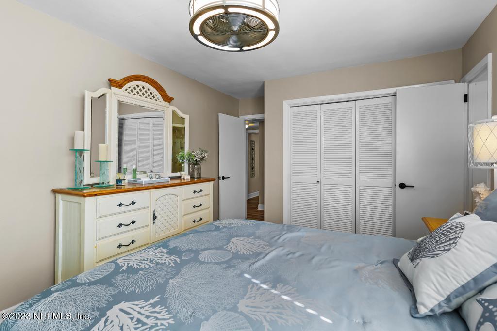 6712 E Road Jacksonville, FL 32216 - Photo 27 of 40 a bedroom with a bed and a mirror on dresser