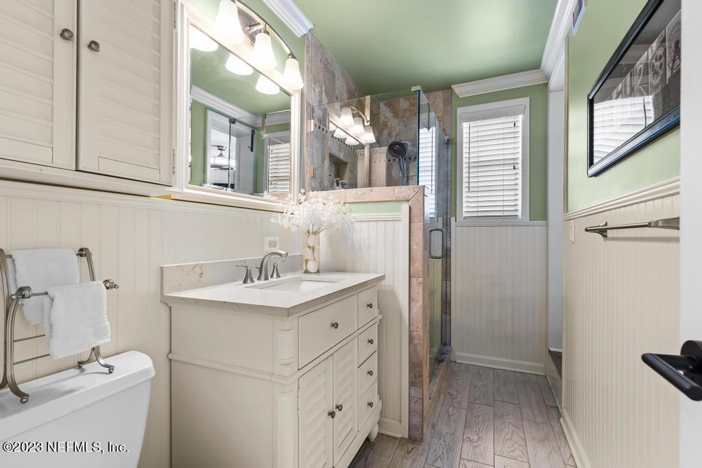 6712 E Road Jacksonville, FL 32216 - Photo 28 of 40 a bathroom with a sink a toilet and a mirror