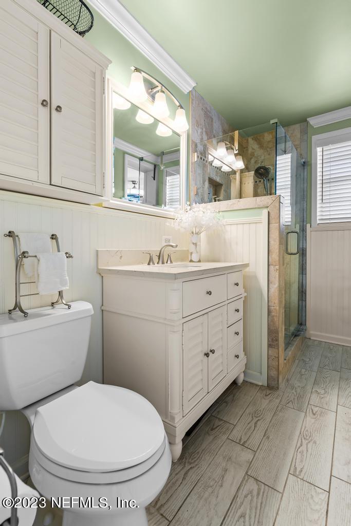 6712 E Road Jacksonville, FL 32216 - Photo 29 of 40 a bathroom with a toilet sink and mirror