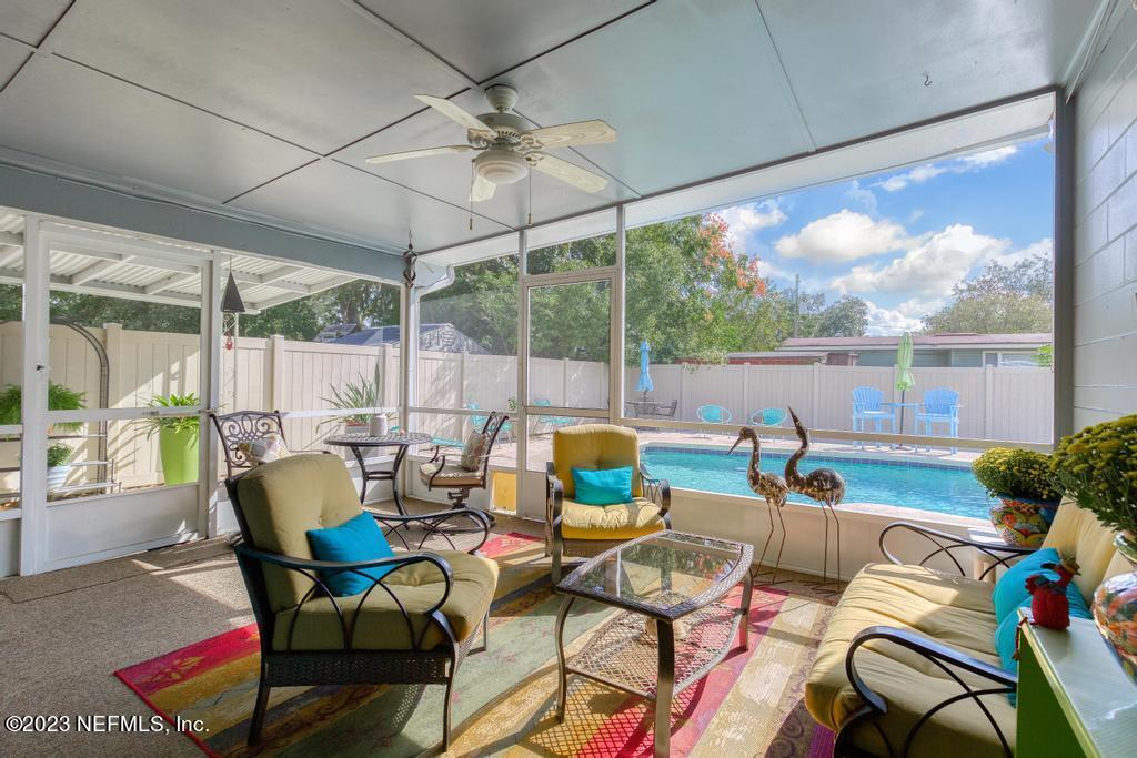 6712 E Road Jacksonville, FL 32216 - Photo 35 of 40 a living room with patio furniture and a floor to ceiling window