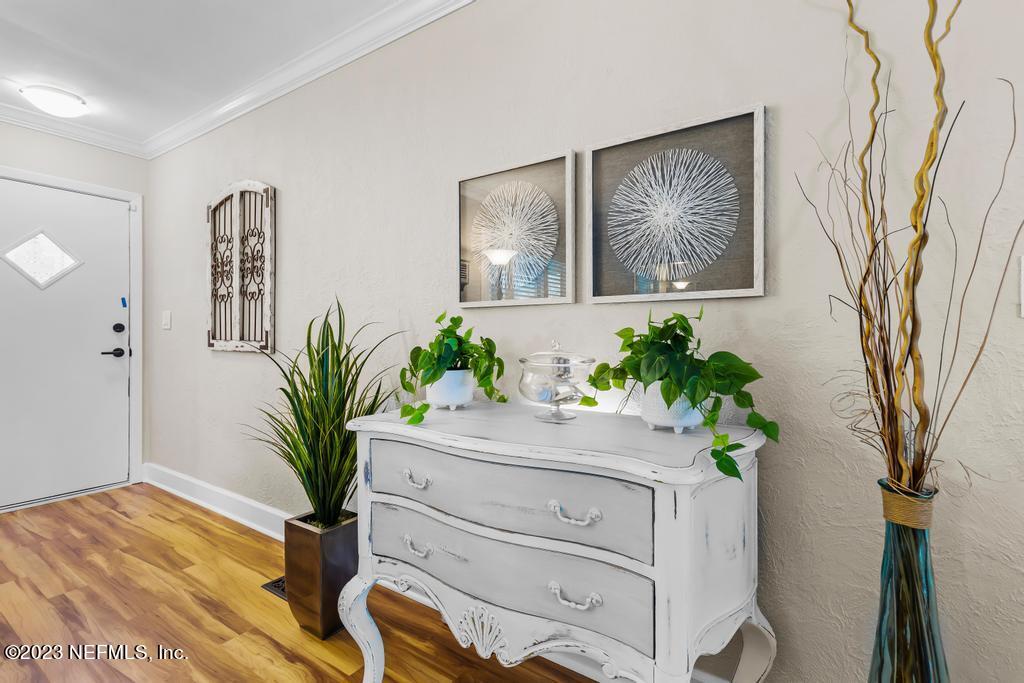 6712 E Road Jacksonville, FL 32216 - Photo 10 of 40 a view of a hallway with furniture and a potted plant