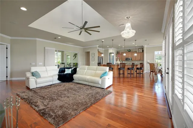 a view of a dining room with furniture wooden floor and chandelier