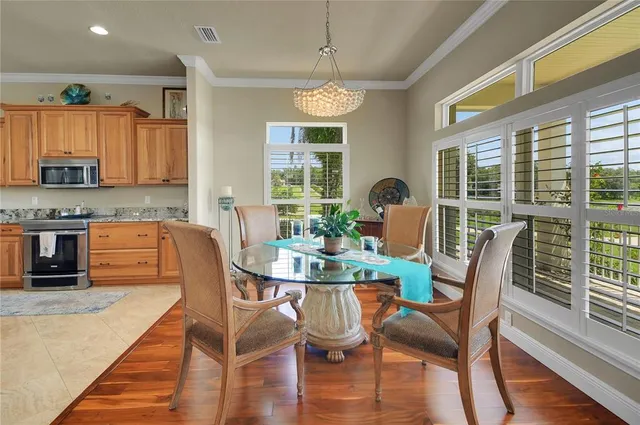 a large kitchen with kitchen island granite countertop a large counter top a sink a window and stainless steel appliances