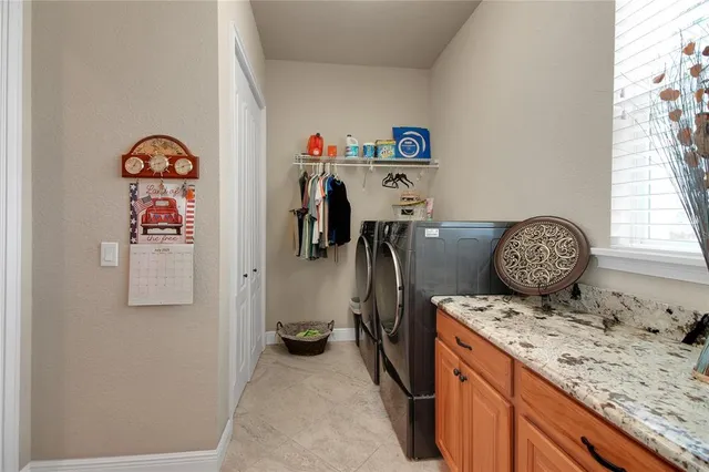an empty room with a window and ceiling fan
