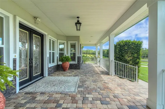 a living room with furniture wooden floor and a chandelier