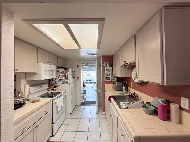 a bathroom with a sink and mirror with toilet