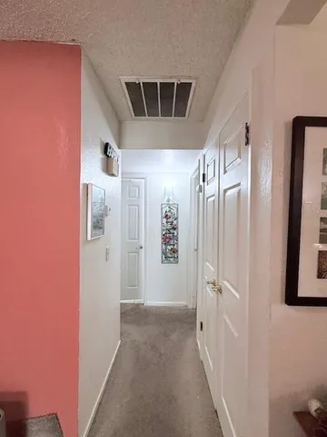 a dining room with a chandelier and wooden floor