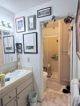 a bathroom with a sink and mirror with toilet
