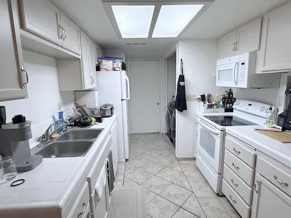 a kitchen that has a sink and cabinets