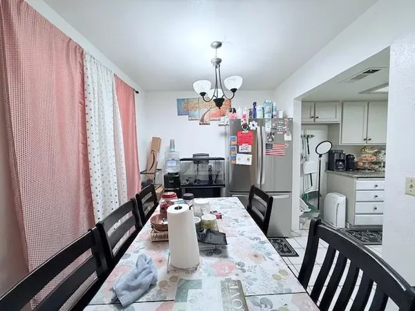 a view of a dining room with furniture window and chandelier