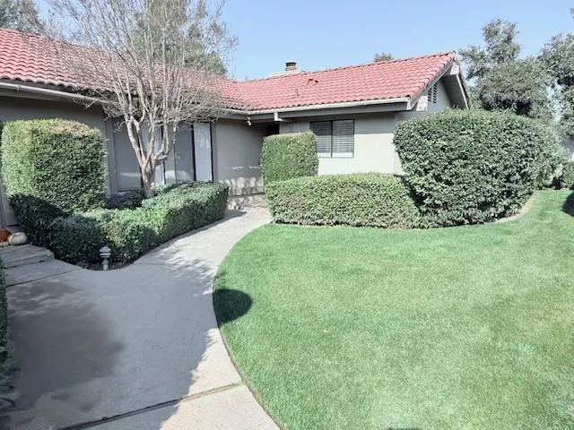 a view of a house with a yard porch and sitting area