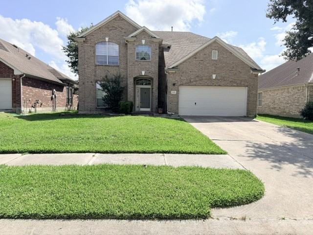 20030 Castlegreen Drive Spring, TX 77388 - Photo 2 of 23 a front view of a house with a yard and garage