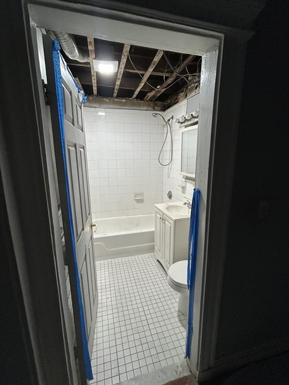 285 Lynn Shore Drive, Unit 308 Lynn, MA 01902 - Photo 5 of 11 a bathroom with a sink a toilet and shower