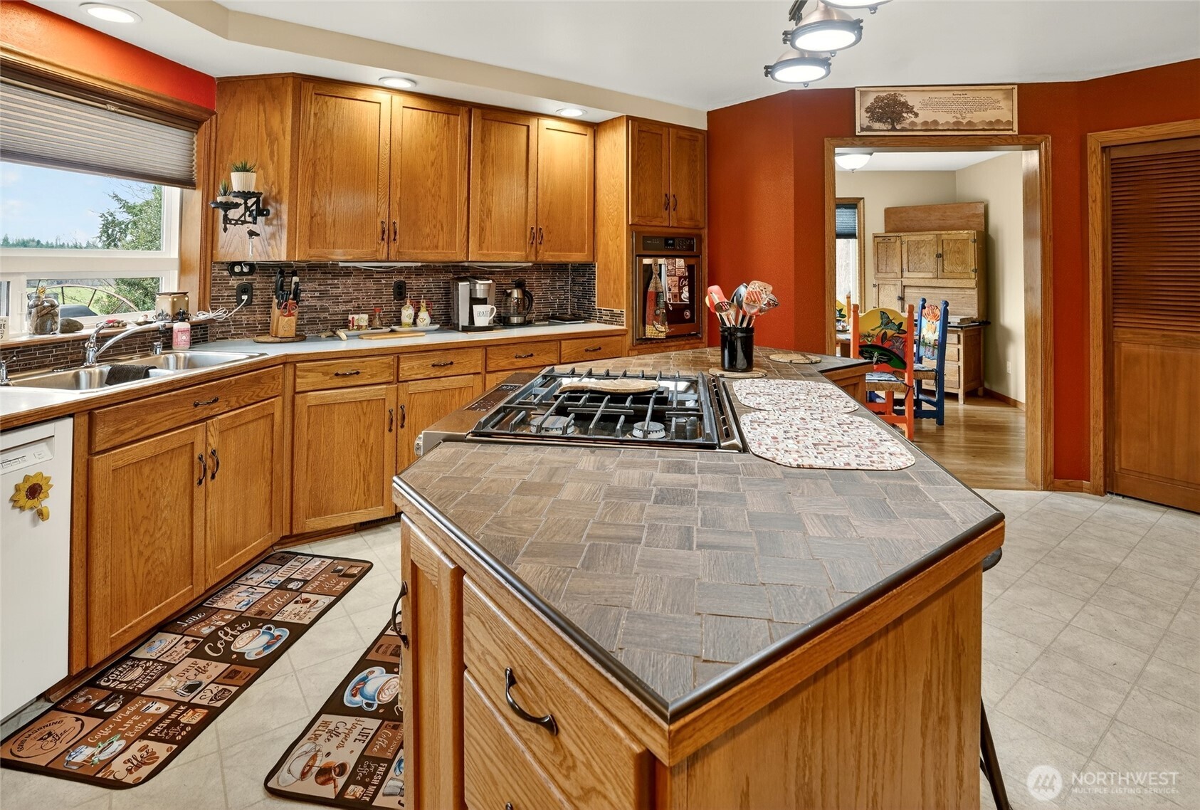 20070 Park Ridge Lane Sedro-Woolley, WA 98284 - Photo 7 of 40 a kitchen with a stove a sink dishwasher and cabinets with wooden floor