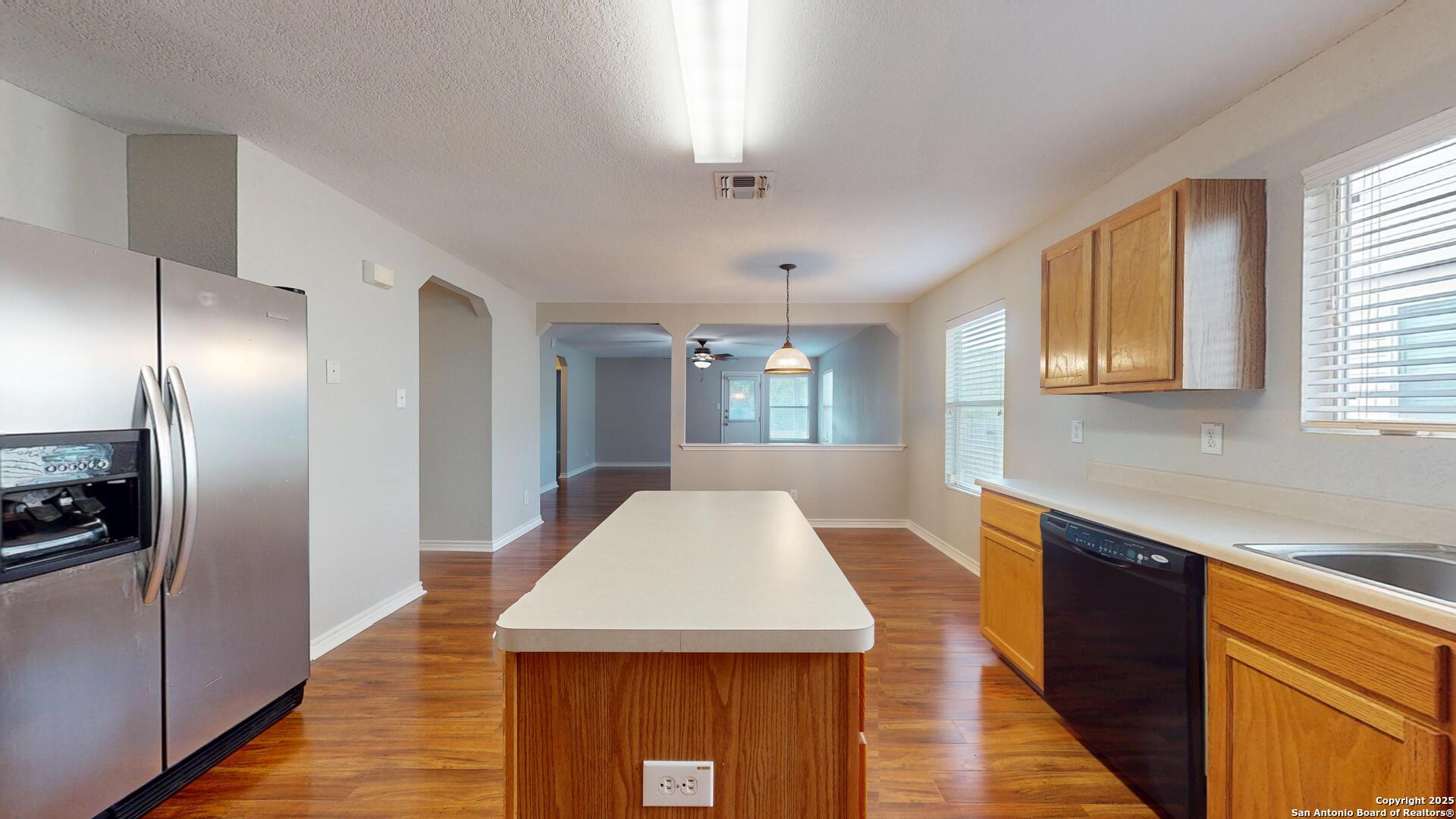 9515 Boatman Pier Converse, TX 78109 - Photo 12 of 41 a kitchen with kitchen island a counter top space a sink stainless steel appliances and cabinets